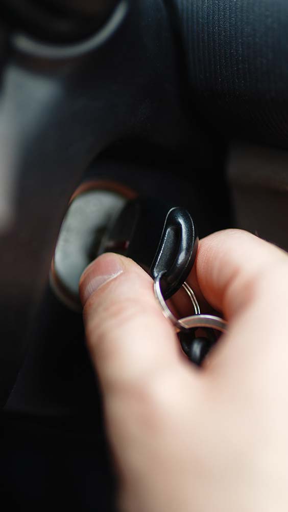 Batteries & electrical service showing a car key turning in the ignition during startup.