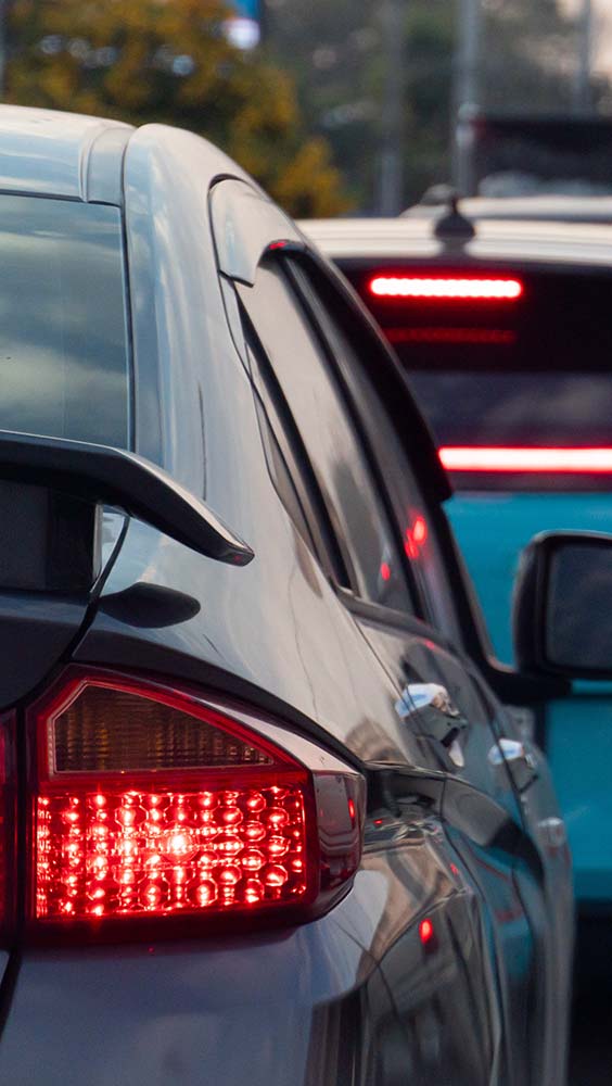 Brake repair close-up of cars in traffic. Brake lights showing.